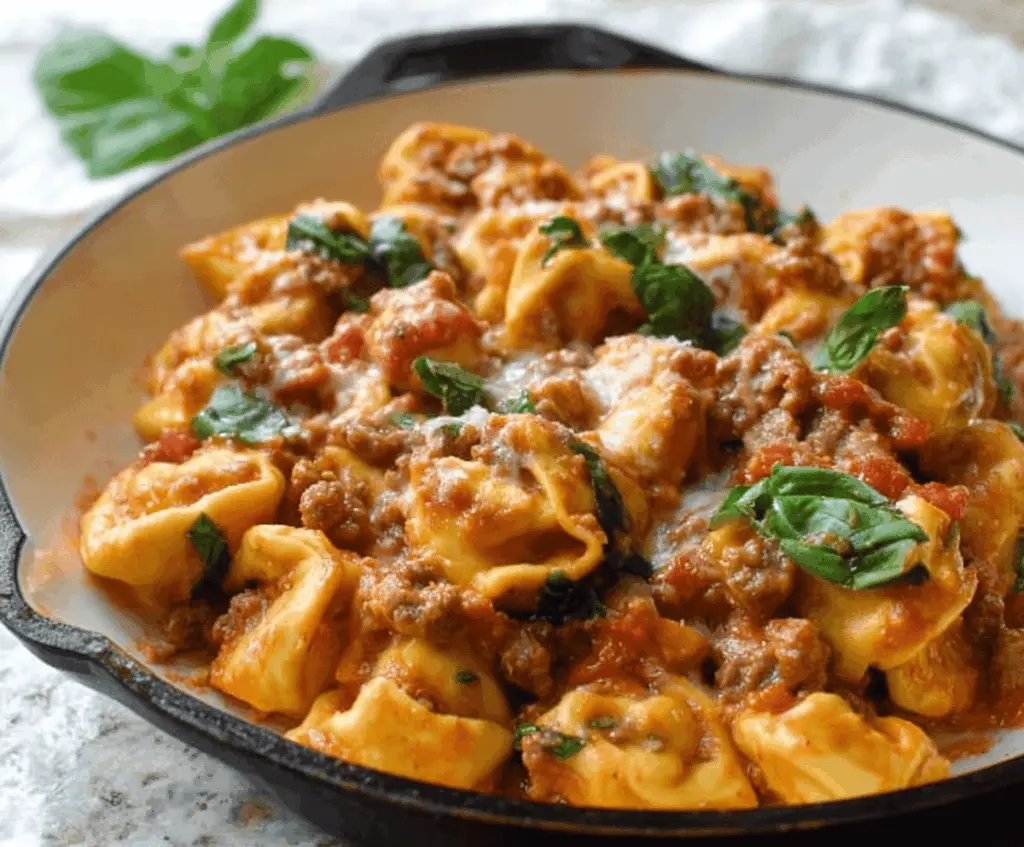 Delicious one-pan tortellini with sausage and fresh herbs in a skillet, perfect for a quick and flavorful meal