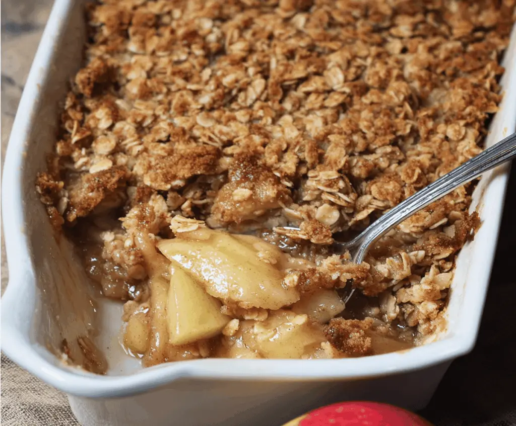 Delicious homemade apple crisp with a golden oat streusel topping, served warm in a baking dish