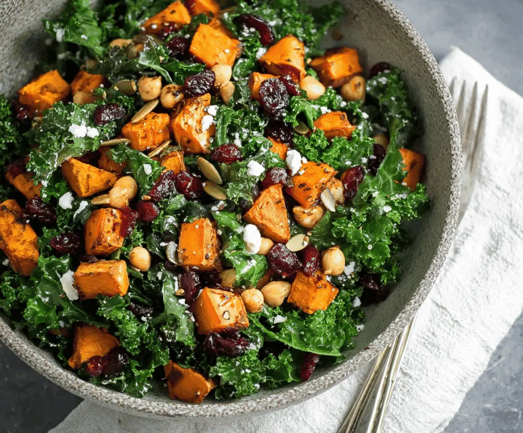Fresh roasted sweet potato and kale salad with colorful vegetables and a light dressing, perfect for a healthy meal.