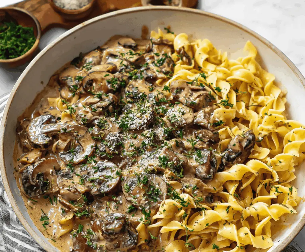 Creamy vegan mushroom stroganoff served over pasta, perfect for a quick plant-based dinner.