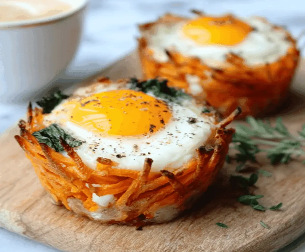 Baked sweet potato egg cups served in a muffin tin, showcasing a healthy breakfast option.