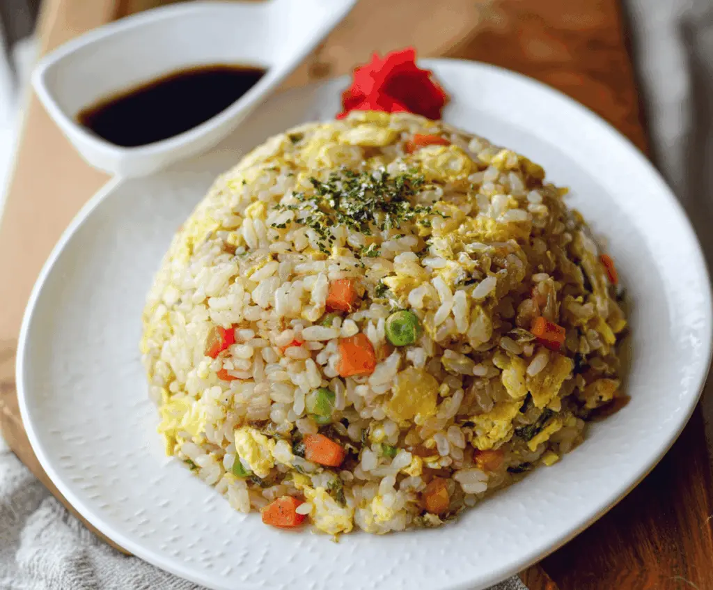 Delicious Japanese Fried Rice with vegetables and tender meat, served on a plate.